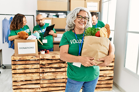 A group of seniors smiling while volunteering