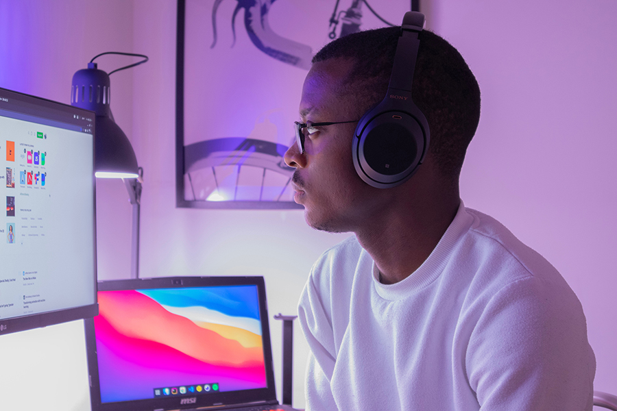 A person with hearing loss using a hearing aid in a modern and accessible workspace.