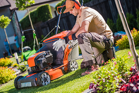 A person wearing hearing protection while doing yard work to prevent injuries and follow safety tips for outdoor work.