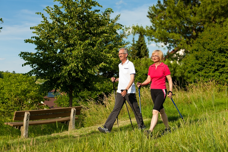 A person walking outdoors for exercise to improve their health and well-being.