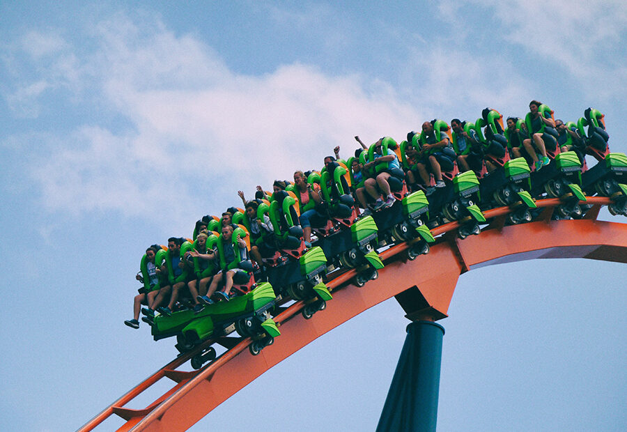 Image of a person with hearing loss using assistive listening devices at a theme park to show accessibility options for visitors with hearing impairments.