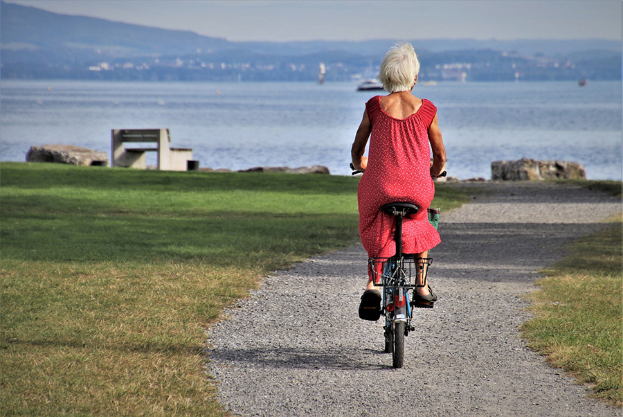 A person with hearing loss enjoying a scenic travel destination during their summer break.