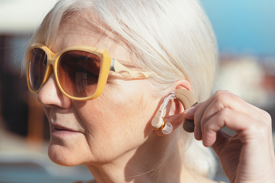 A person packing hearing aids for travel