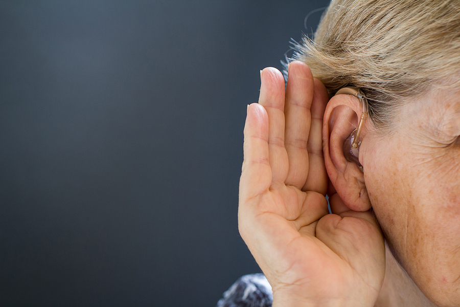 A person holding their hand to their ear