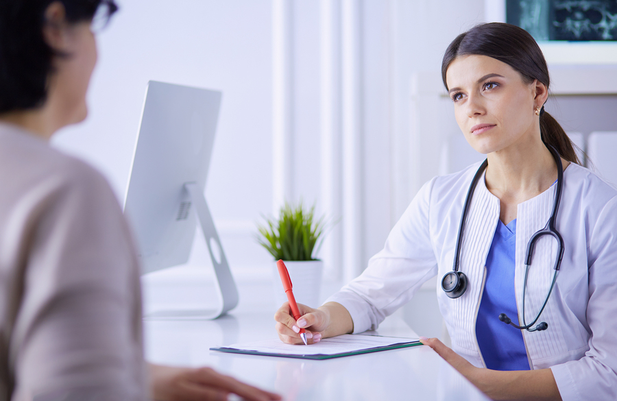 A person scheduling a doctor's appointment for hearing loss and seeking communication strategies for better understanding.