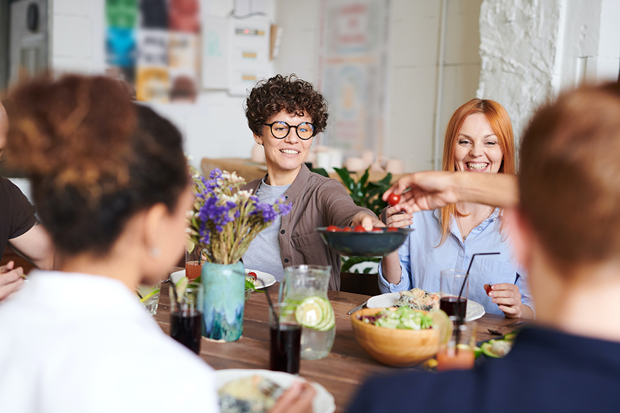 A dinner party with accessibility considerations for guests with hearing loss. This image shows a beautifully set table with a variety of dishes and drinks