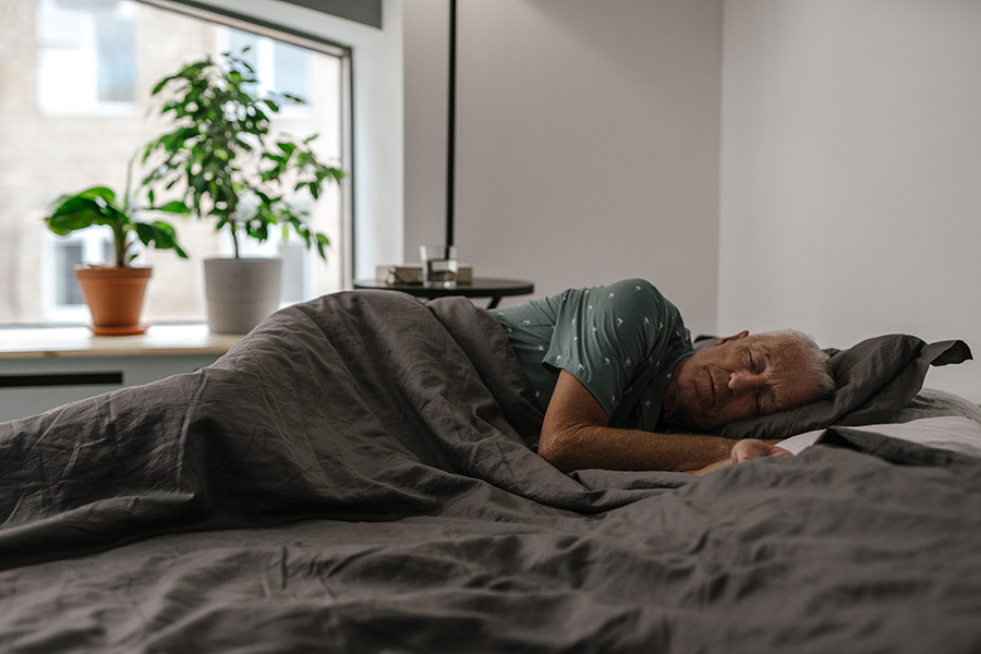 A person sleeping peacefully in a comfortable bed