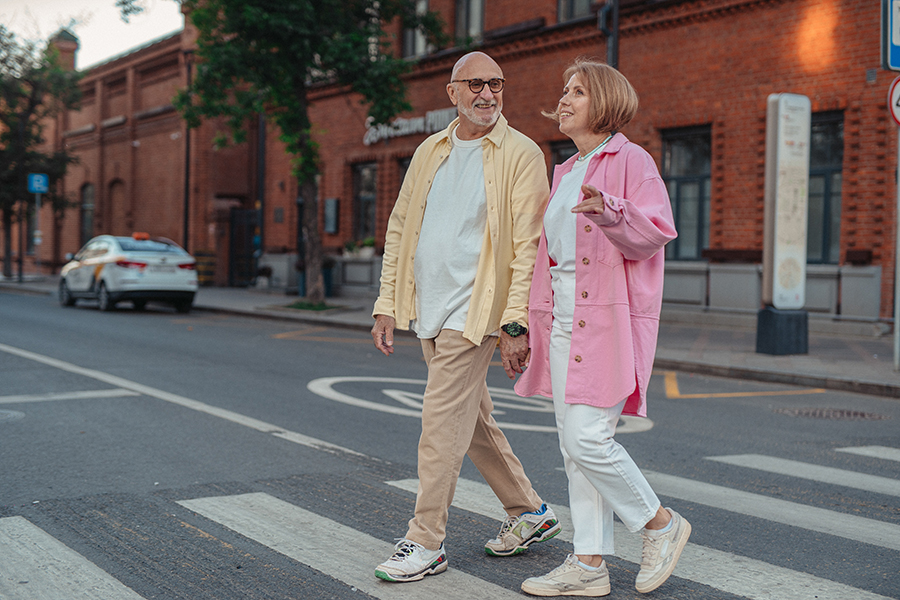 A person walking outdoors as part of their fitness routine.