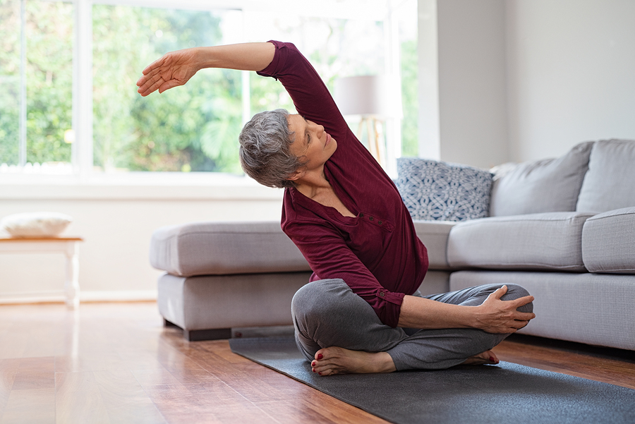 Senior man doing indoor exercises to stay active and healthy.