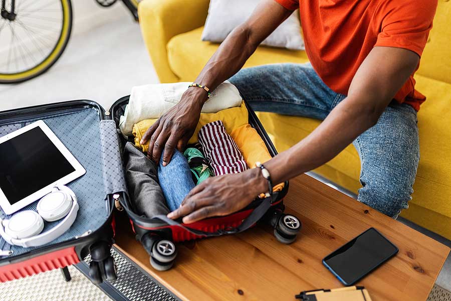 A person with hearing loss using communication devices and accessories while traveling to improve their communication and overall travel experience.