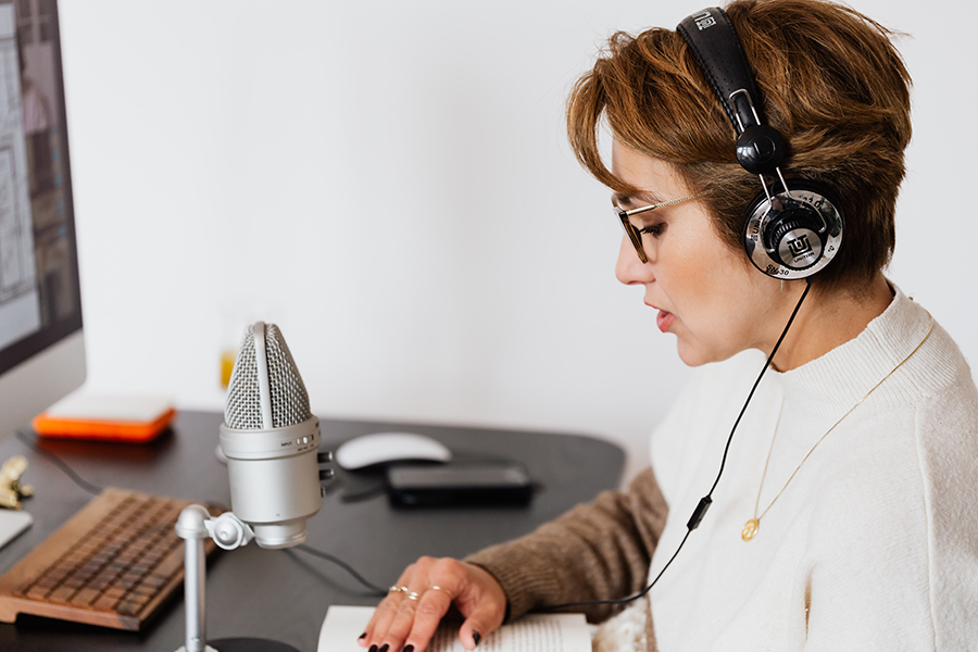 A person with hearing loss listening to a podcast about communication.