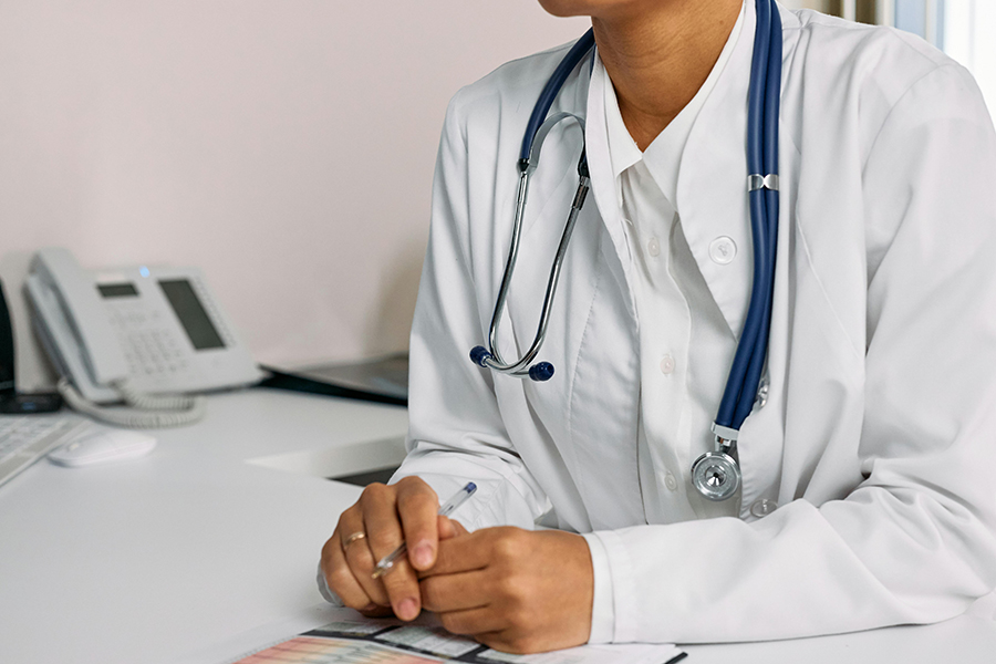 A person consulting a doctor for signs of hearing loss.