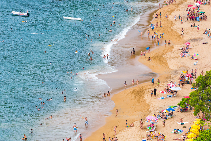 A person with hearing loss enjoying a relaxing beach vacation with accessibility features.