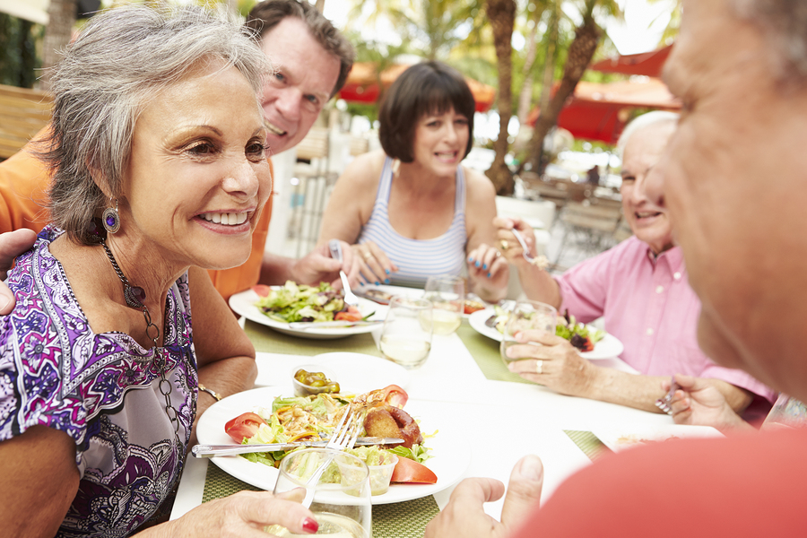 A person with hearing loss using communication strategies while dining out.