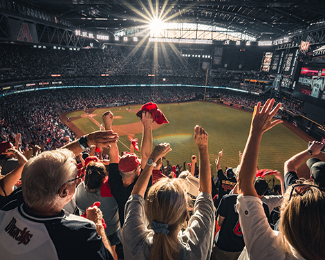 A person with hearing loss at a sporting event using communication strategies to participate and enjoy the experience.