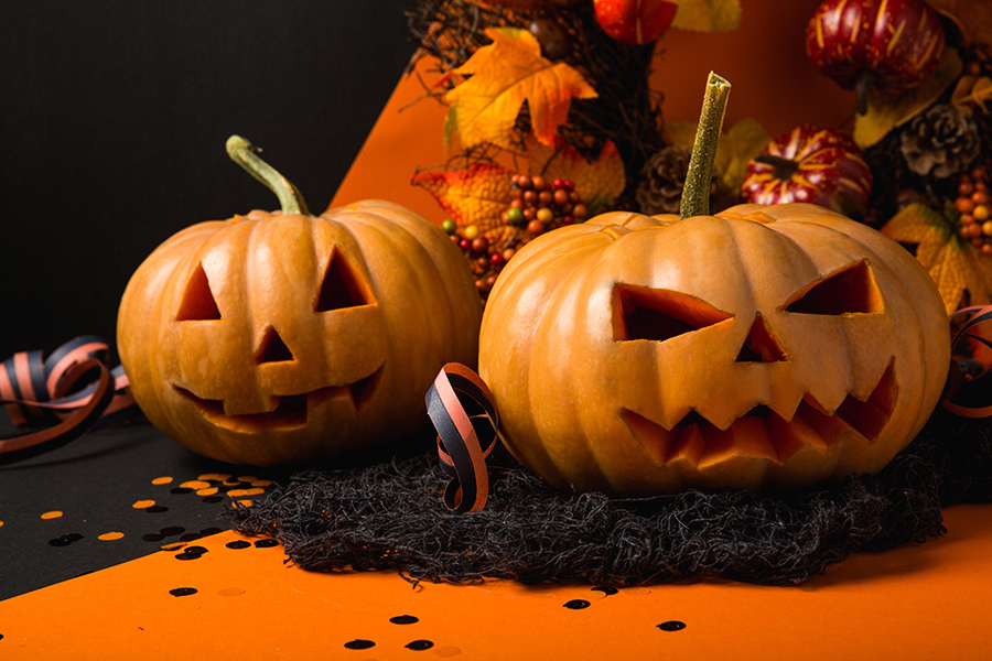 A group of friends with hearing loss enjoying a Halloween party with accessibility features such as sign language interpreters and captioning on screens.