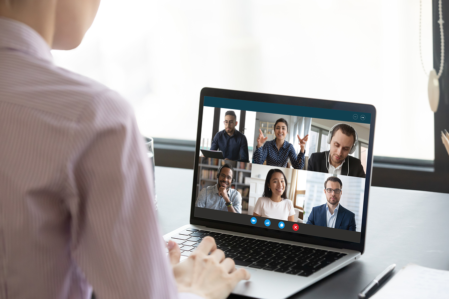 Image of a person using sign language during a virtual meeting to accommodate for hearing loss.