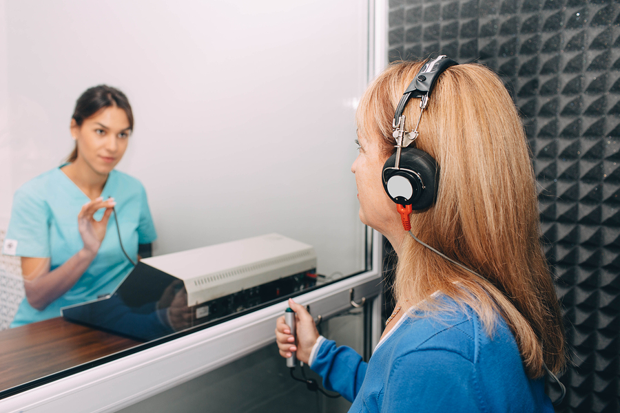 A person undergoing a hearing screening to check for hearing loss. Different types of hearing loss are also being explored in the search.