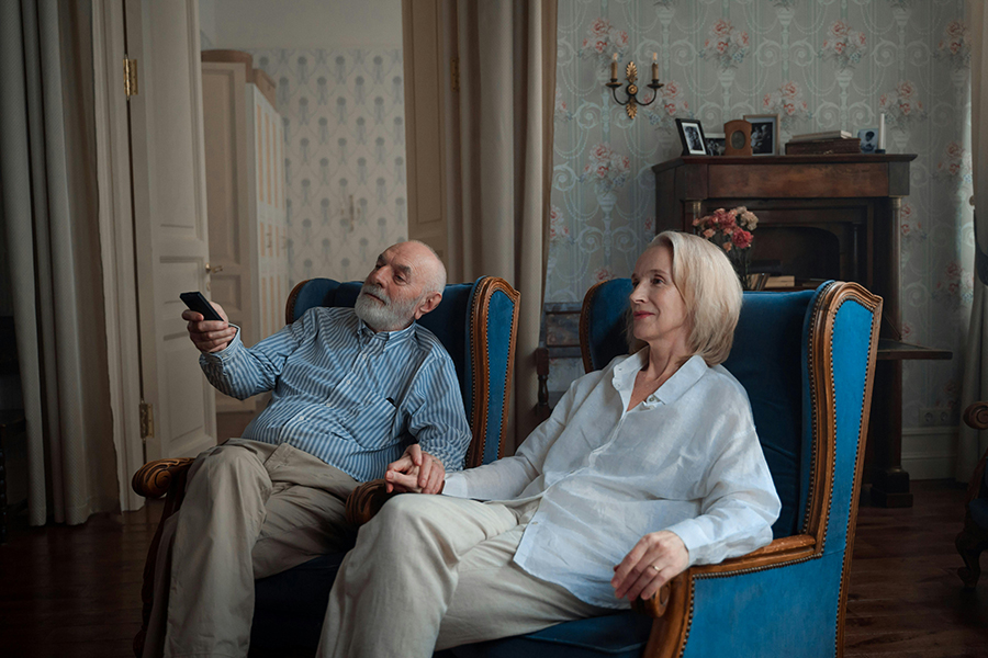 A person with hearing loss watching TV and struggling to hear the dialogue clearly.