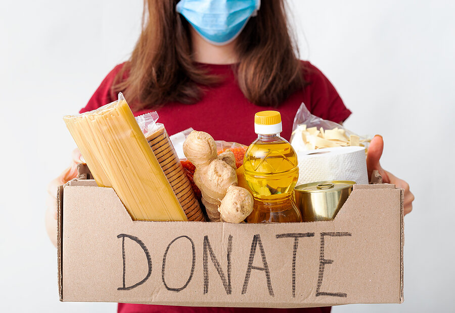 Image of hands holding a heart with the text "Holiday Giving - Ways to Give Back - Charitable Donations" to inspire people to find ways to give back during the holiday season.