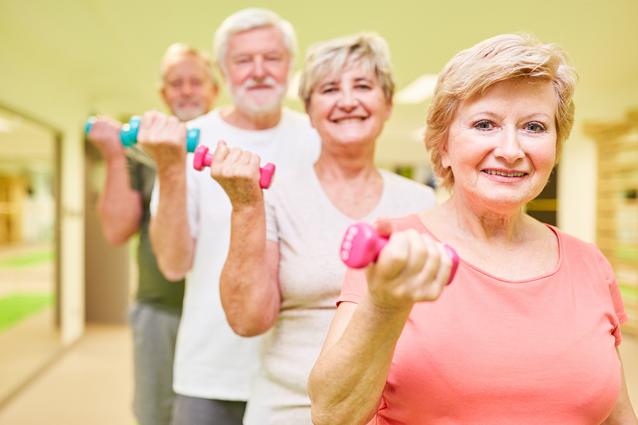 A group of seniors participating in weight training exercises to improve their health and fitness.