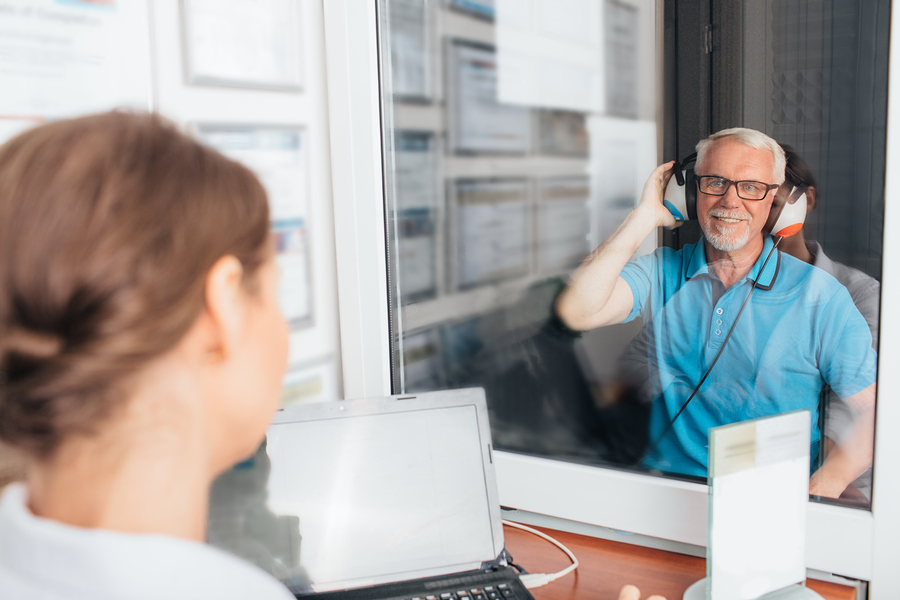 Audiologist conducting a hearing test for a patient experiencing hearing loss. Find information on hearing tests